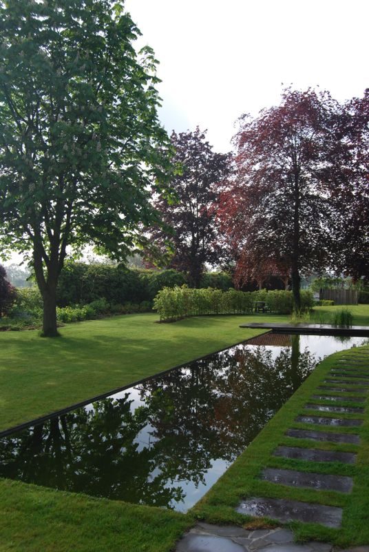 Waterspiegel met stapstenen in gazon
